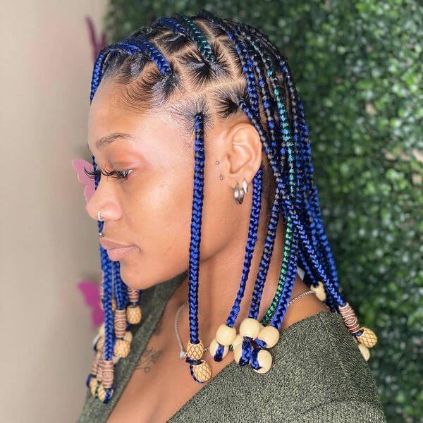 Centered- parted knotless braids with beads and highlights
