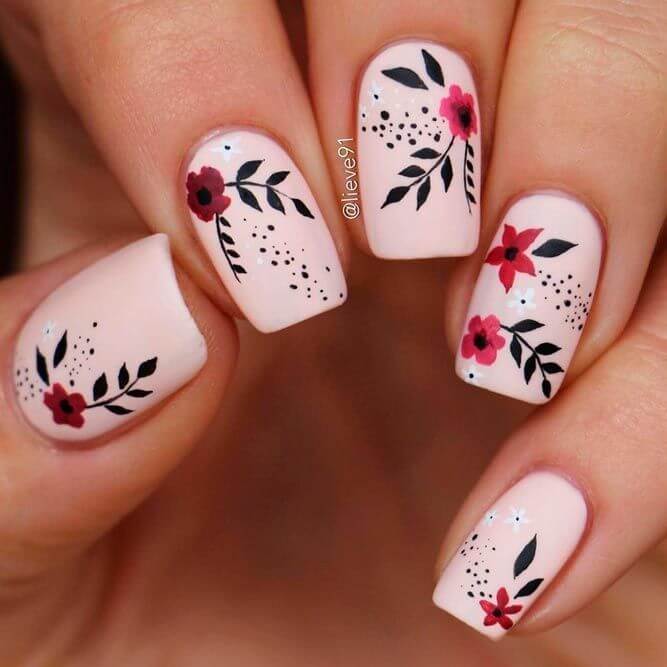 Two acrylic nails decorated with flowers